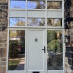 Accoya door screen in Pebble Grey with black iron hardware