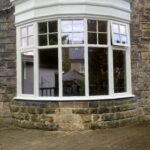 Segmented bow bay with flush casement windows
