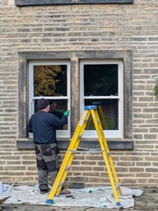 Window fitter installing double glazed sash windows