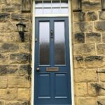 Accoya timber front door finished in Stiffkey Blue with antique brass door fittings