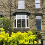House in Ilkley with a segmented bay window and Stiffkey Blue timber door