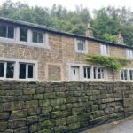 Converted barn with flush casement windows in Farrow & Ball Worsted