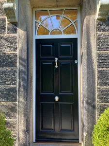 Jet Black six panel entrance door with a sunburst fanlight with glass
