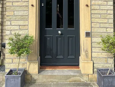Three slim bolection panels on a jet black door
