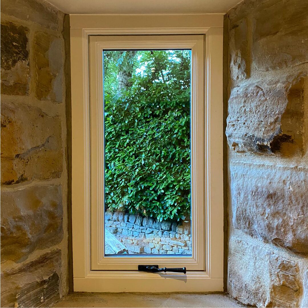 Double-glazed casement window with black iron hardware