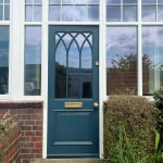 Gothic style Accoya timber door in Farrow and Ball Hague Blue and aged brass hardware