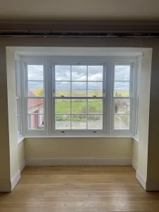 Square bay with timber box sash windows
