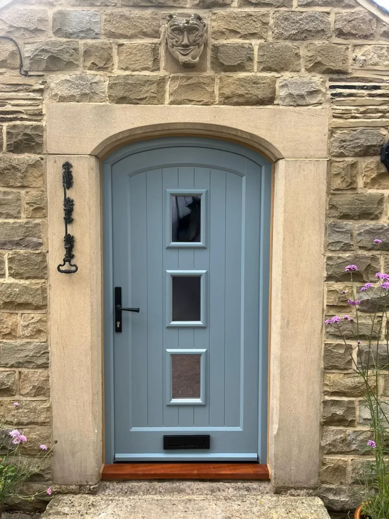 Arched exterior door in Farrow and Ball Selvedge with black pewter hardware