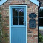 Blue timber stable door with crucifix bar