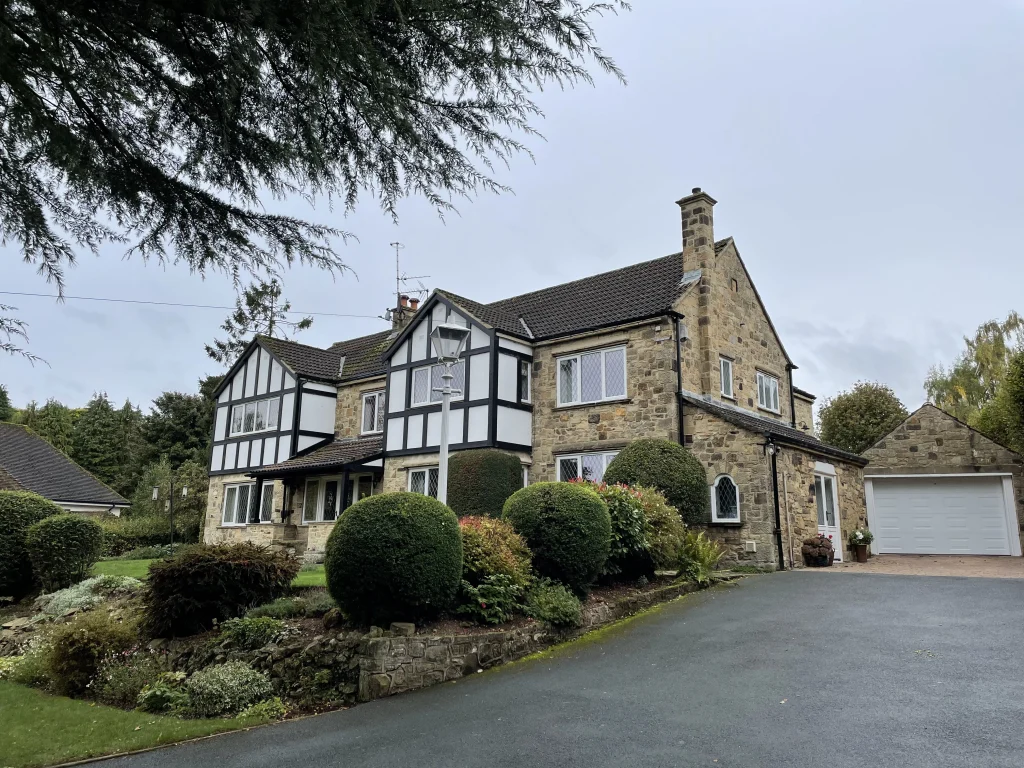 Large house with timber Flush casements with diamond leaded glass