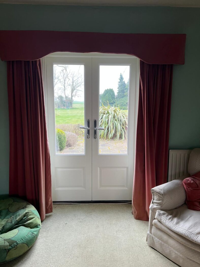 Living room with new white timber double doors