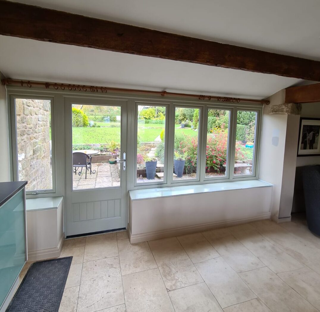 Conservatory with new pebble grey timber door and screen
