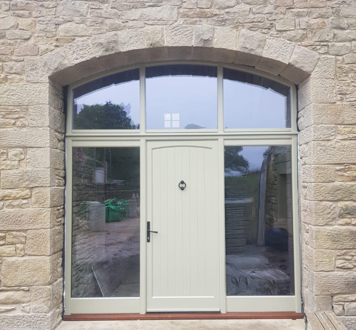 New build with an arched timber door screen