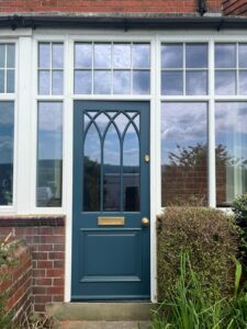 Gothic style Accoya timber door in Farrow and Ball Hague Blue and aged brass hardware