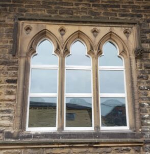 Shaped Gothic style hopper windows.