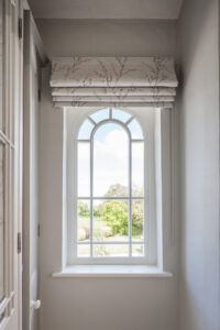 Arched timber window with shaped bars in Withinlee House Farm