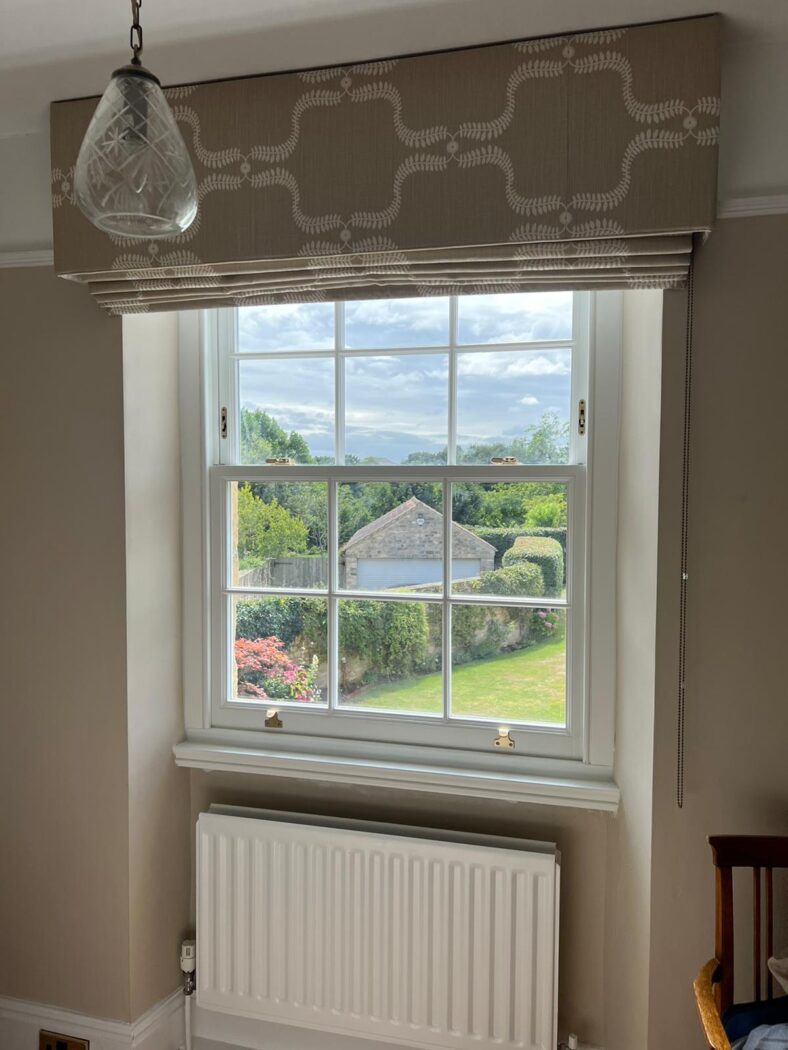 Bedroom window with an accoya wooden sash window and a large fabric blind