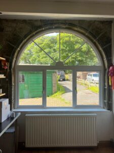 Semi circular sunburst wooden window 
