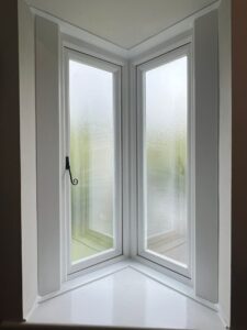 Interior view of an oriel bay window with traditional monkey tail hardware