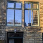 Two tmber stormproof casement windows colourmatched to studio green in a 19th century house