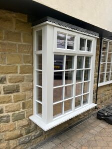 House with a protruding square bay window with Georgian bars