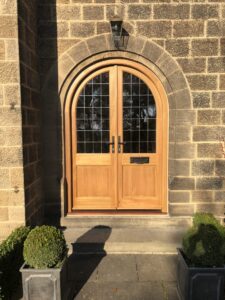 Bespoke timber arched door with square leaded glass