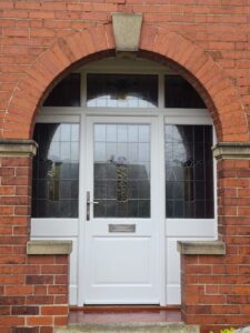 White timber front door with encapsulated decorative glass