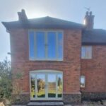 House with a set of french doors and balcony doors