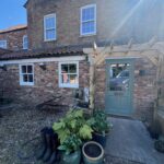 Farmhouse conversion with sash windows and a Card Room Green door