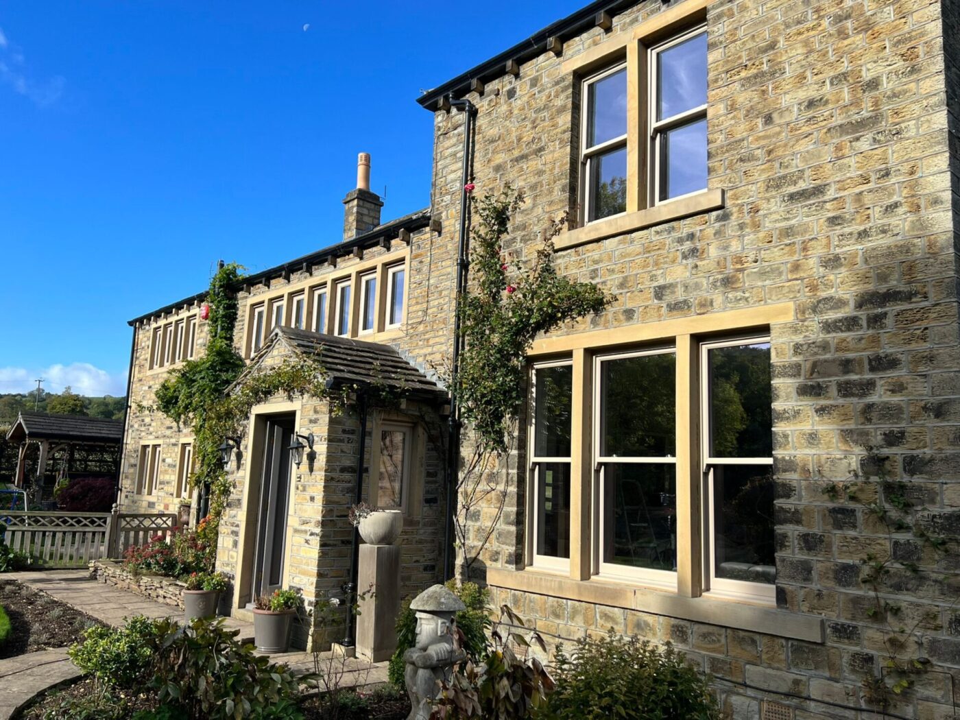 Large house on a sunny day with new sliding sash windows