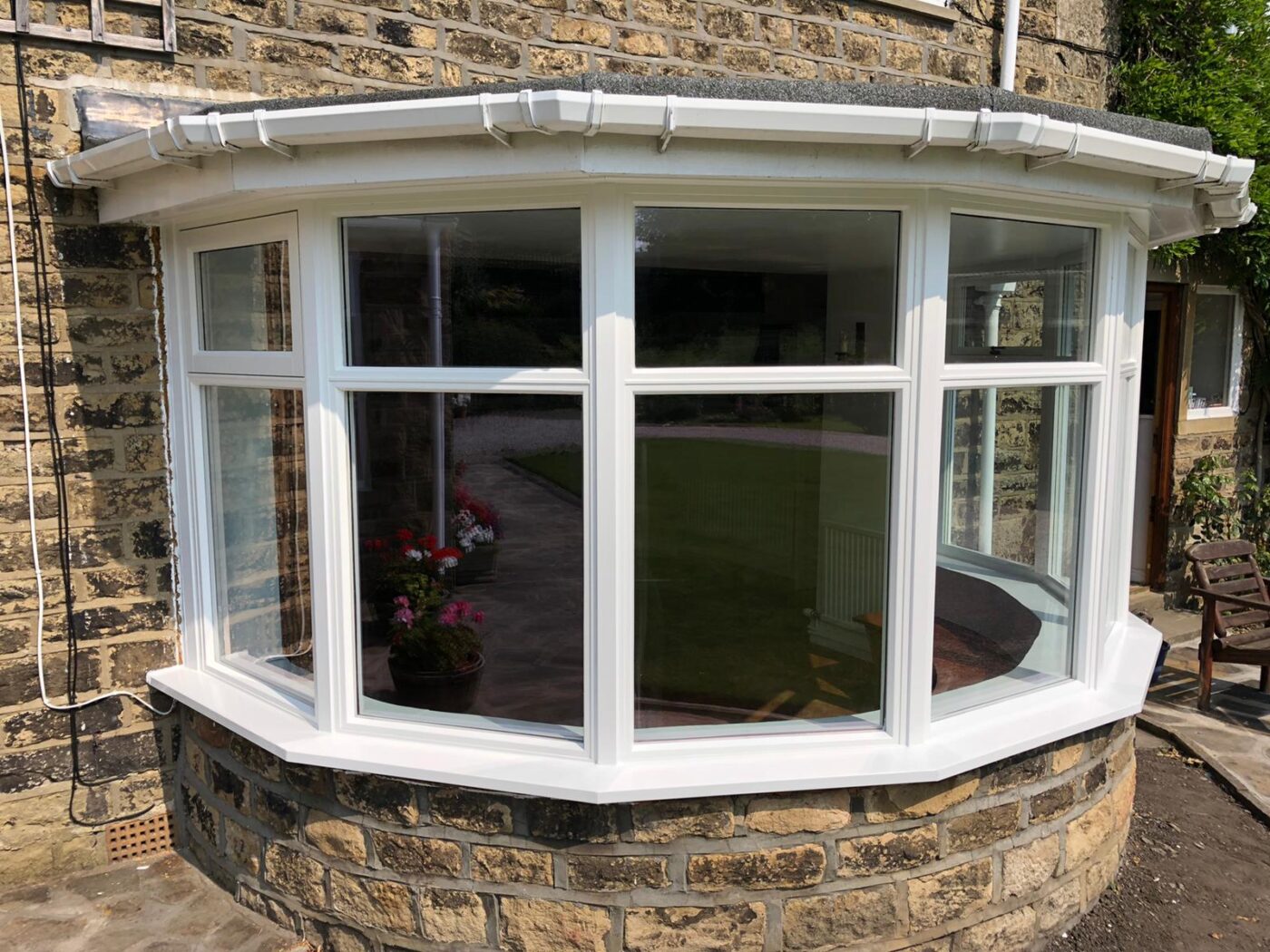 Wooden bow bay window on a bright summers day