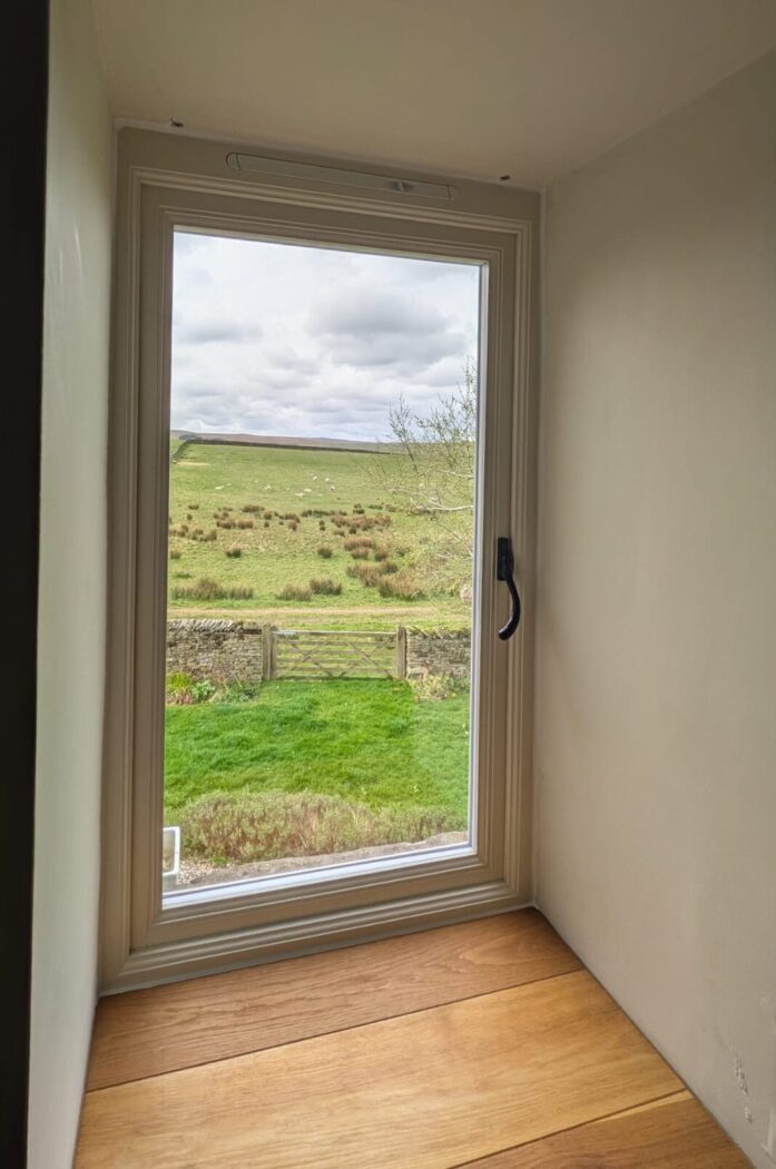 Cream flush casement window with a view out over the Yorkshire Dales