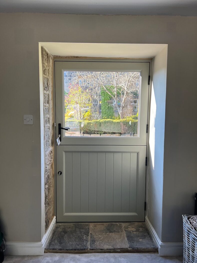 Pebble Grey Accoya stable door in a real stone floor hall