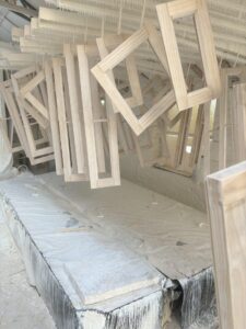 Rack of timber window frames hanging to dry in the Patchett Joinery workshop following deluge