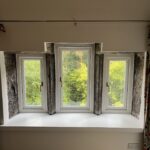 Three Accoya casement windows sat inside an exposed stone reveal