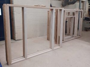Two timber venetian sash window frames in the Patchett Joinery workshop