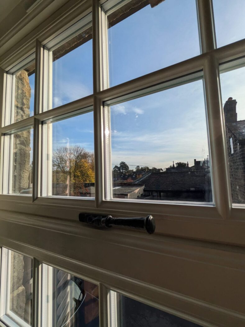 Close up shot of a window with Georgian bars and period iron hardware