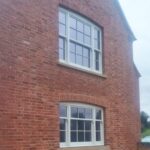 Red brick self-build with two twin venetian sash windows