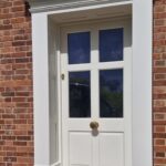 Side view of a bespoke accoya front door with a door surround