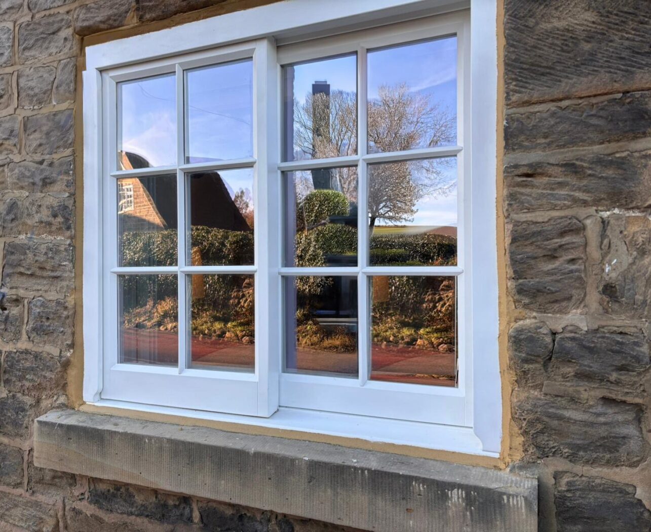 White Yorkshire Sliding Sash with Georgian bars in a Yorkshire stone cottage