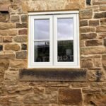 A stone barn conversion in Yorkshire with a replacement wooden flush casement window
