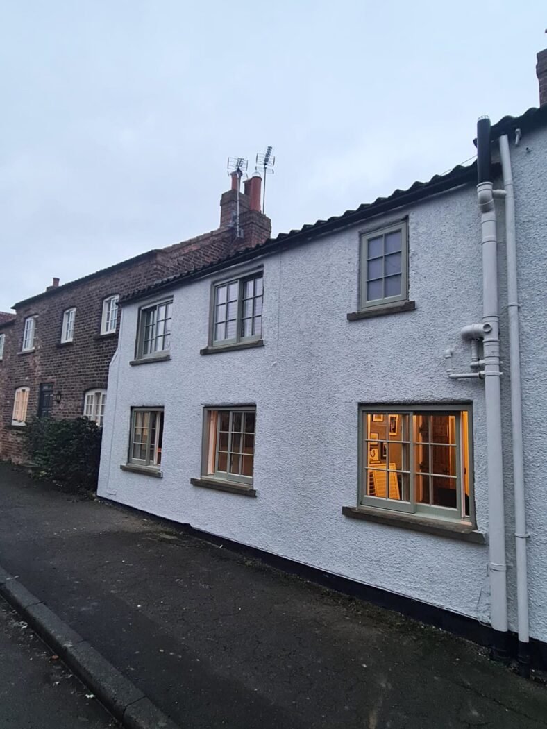 White wash cottage in the yorkshire village of Whixley with pebble grey wooden yorkshire sashes