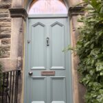 Large Accoya timber front door in Little Greene Livid with shaped door panels and a sandblasted arched fanlight reading '18 Tivoli Place'