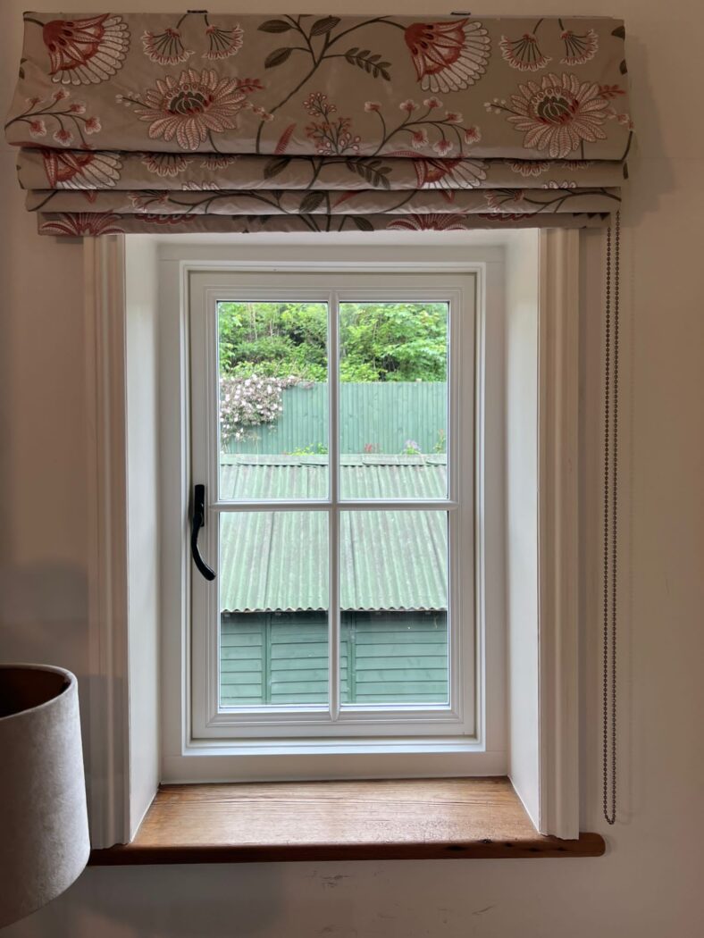 Single product shot of a Heritage Flush Casement window with a crucifix bar and black iron hardware