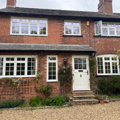 English house with white heritage flush casement windows and timber front door