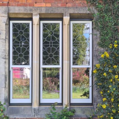 Narrow Concealed Balance Sash windows in Jet Black with decorative glass