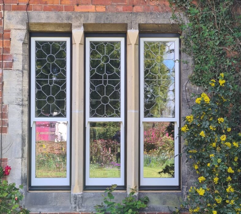 Narrow Concealed Balance Sash windows in Jet Black with decorative glass
