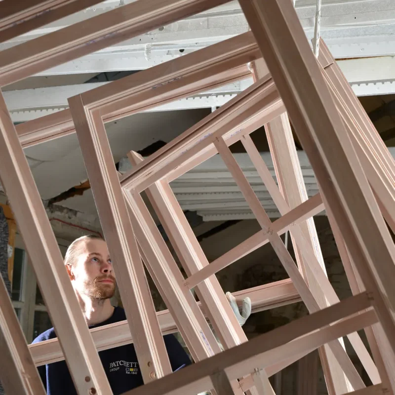 Patchett Joiner inspecting timber windows in the factory