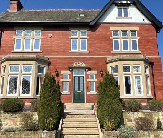 1920s red brick house with decorative glass casement windows